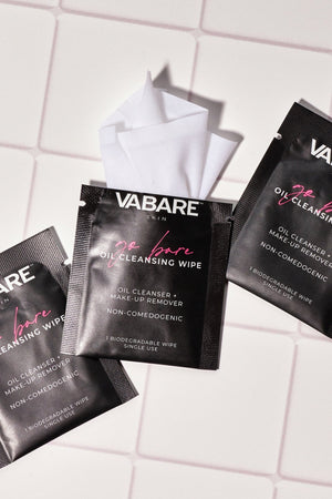 Three VABARE Go Bare Oil Cleansing Wipes on a white tiled background
