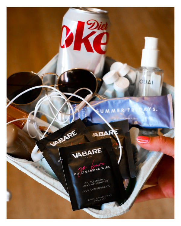 Basket with Diet Coke can, sunglasses, and various items including Vabare packets.