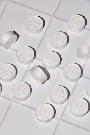 White compressed facial towels with a VABARE logo on a white surface