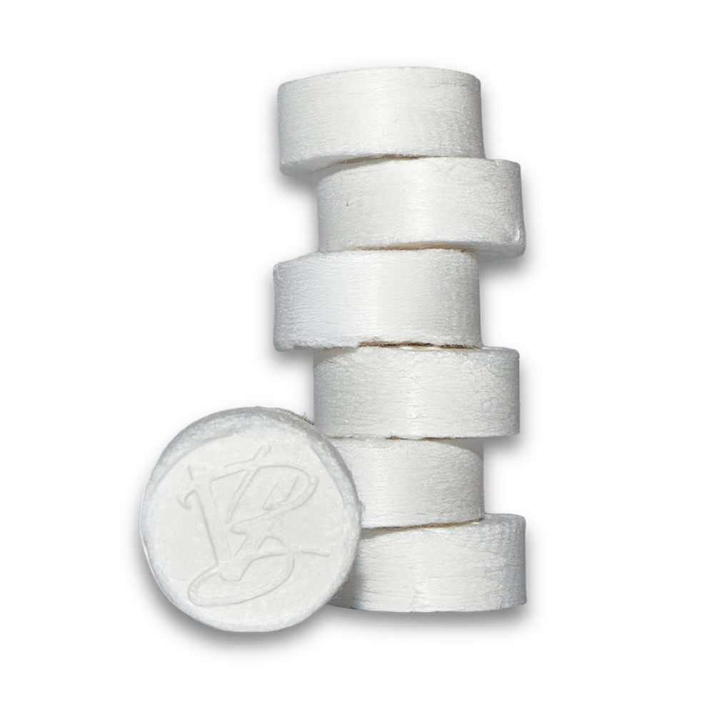 VABARE biodegradable compressed facial towels in a stack of 6 with one in the front showcasing the logo