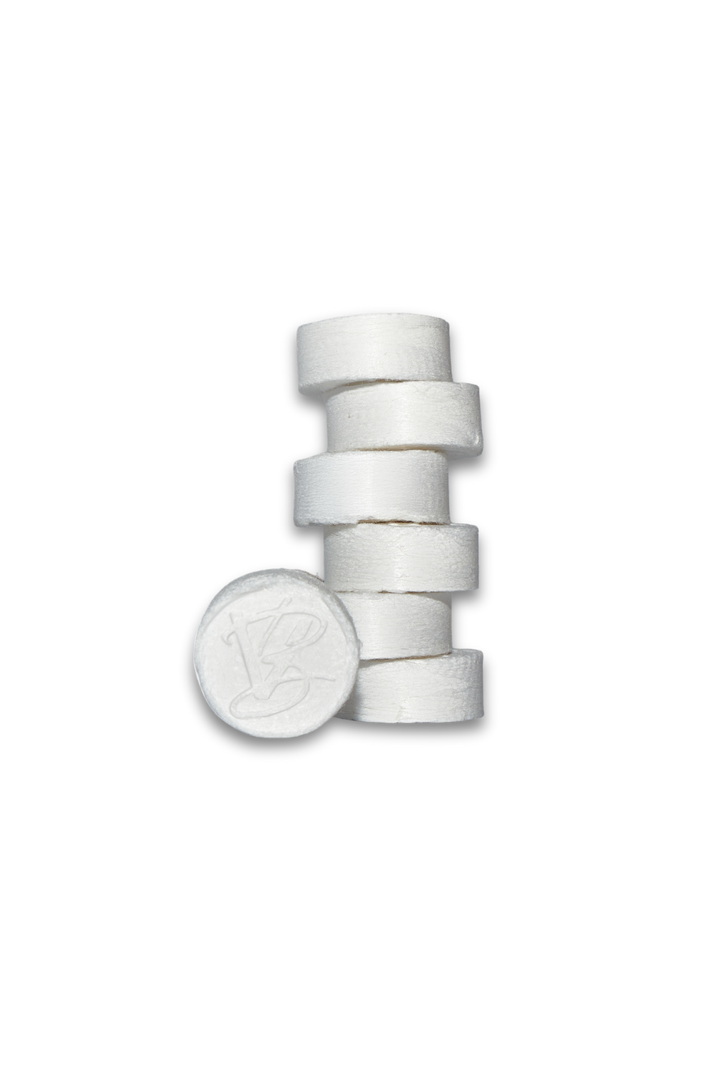 Stack of white compressed facial towels featuring a VABARE logo on the front