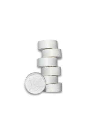 Stack of white compressed facial towels featuring a VABARE logo on the front